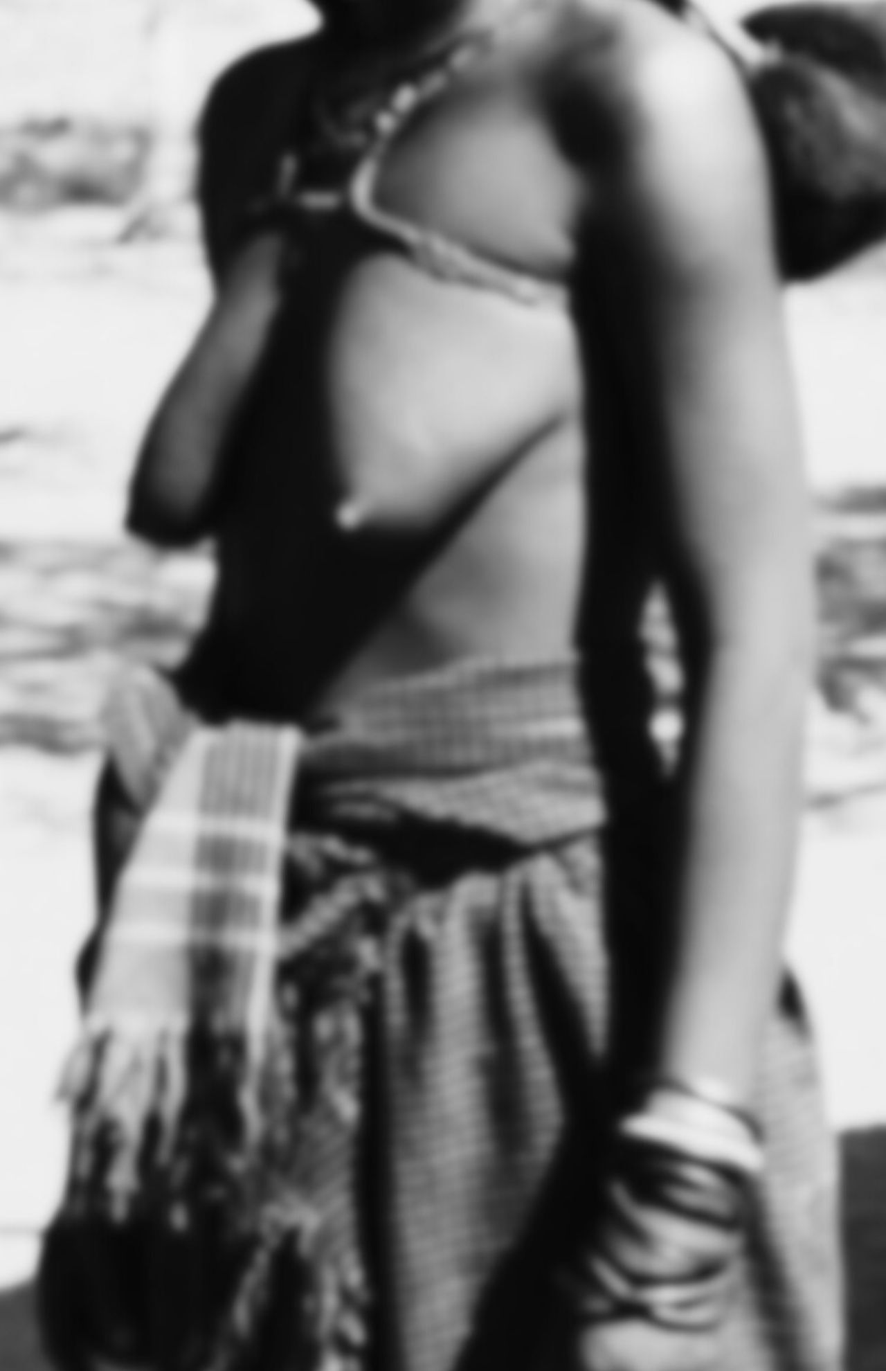 African woman with breasts exposed natural and heritage of labia stretching.