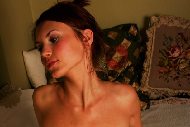 Natasha sitting by the window wearing a seethrough mesh.